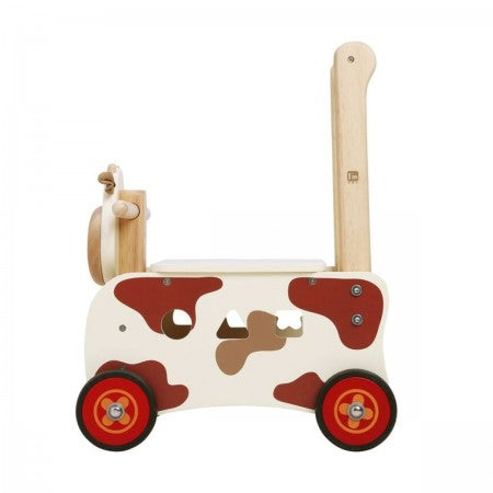 I'm Toy Walk And Ride Cow Sorter. Wooden toy cow with wheels on a white background