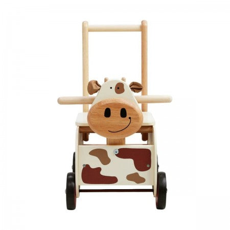 I'm Toy Walk And Ride Cow Sorter. Wooden toy cow with wheels and a handle on a white background