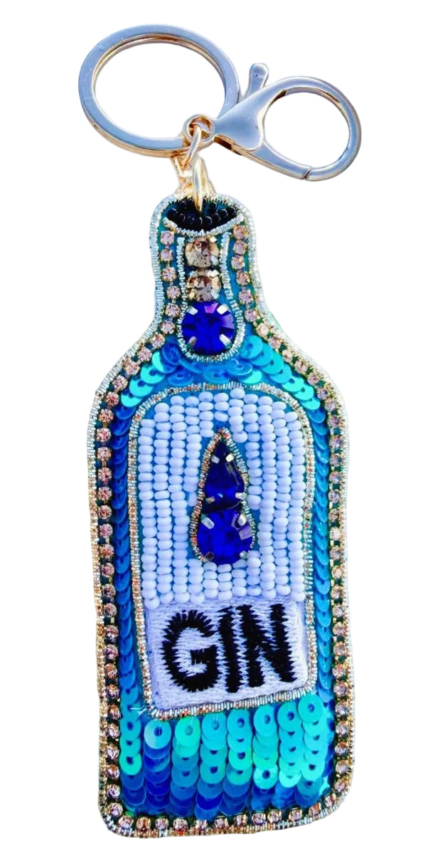 Keychain shaped like a bottle labeled 'GIN' with blue and gold details.