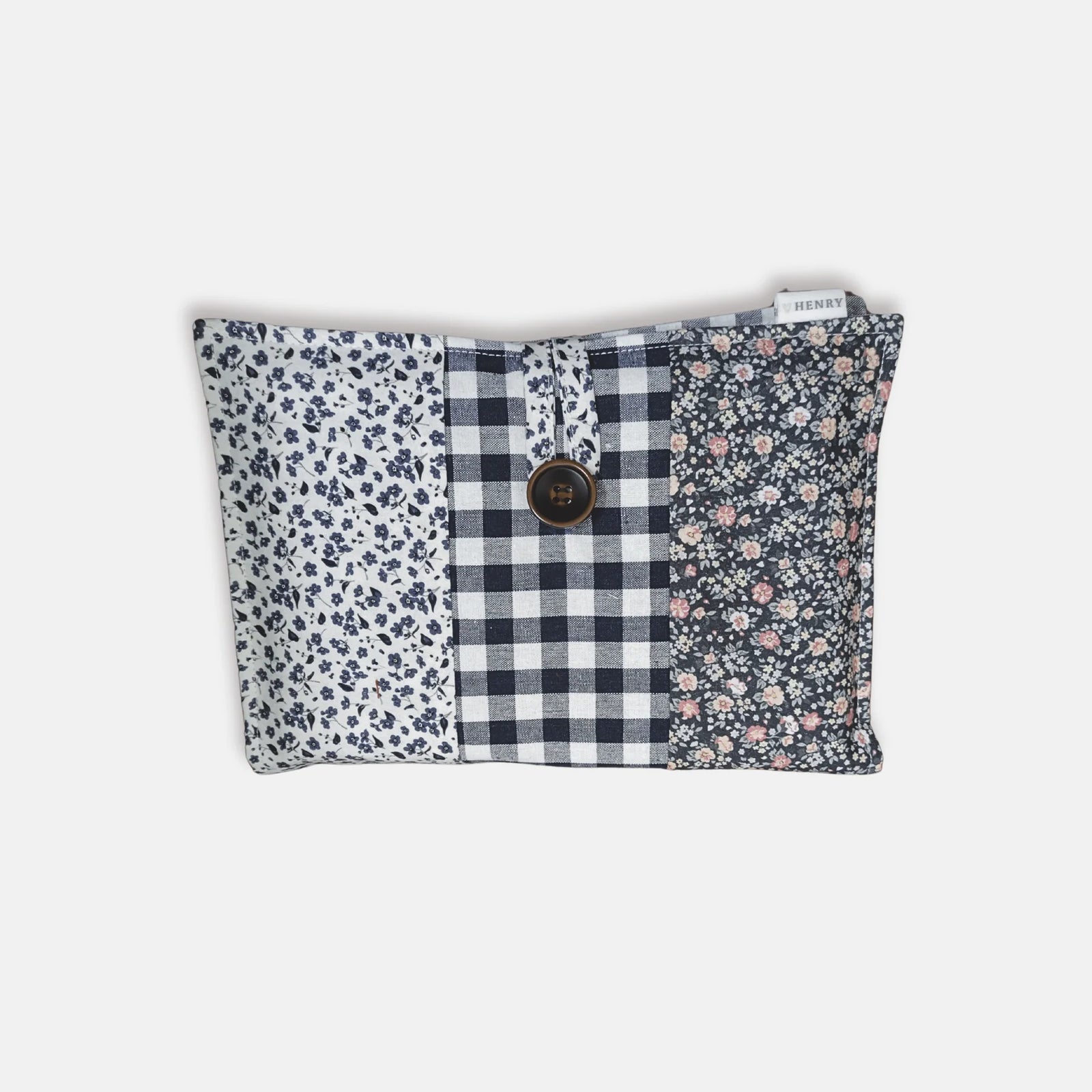 Floral and checkered pouch on a white surface