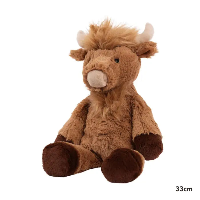 Plush toy cow with horns on a white background