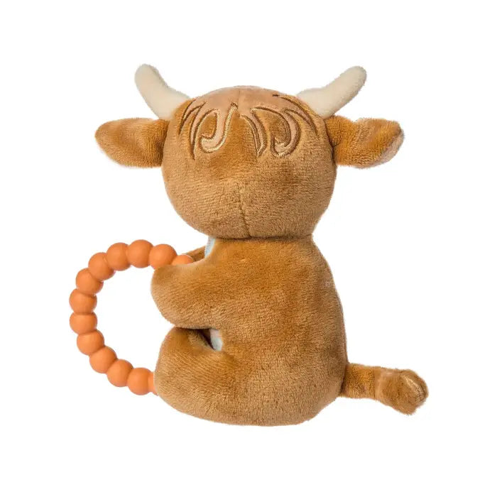 Plush highland cow toy with a teething ring on a white background