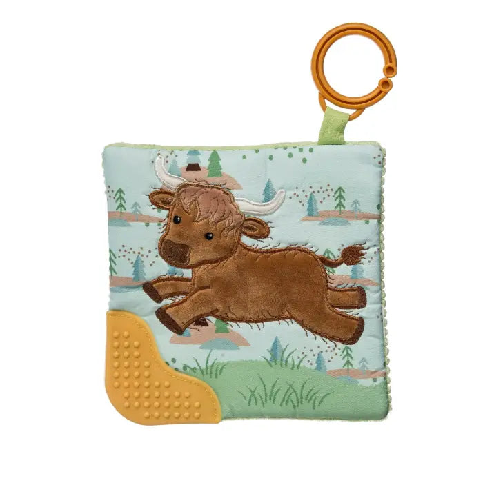 Children's soft toy with a cow design on a white background