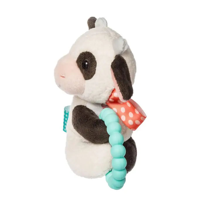 Plush cow toy with a teething ring on a white background