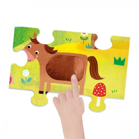 Tactile Puzzle Montessori Farm. Children's puzzle with a horse design on a yellow background, held by a hand.
