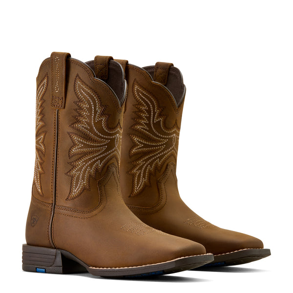 Pair of brown cowboy boots with intricate designs on a white background