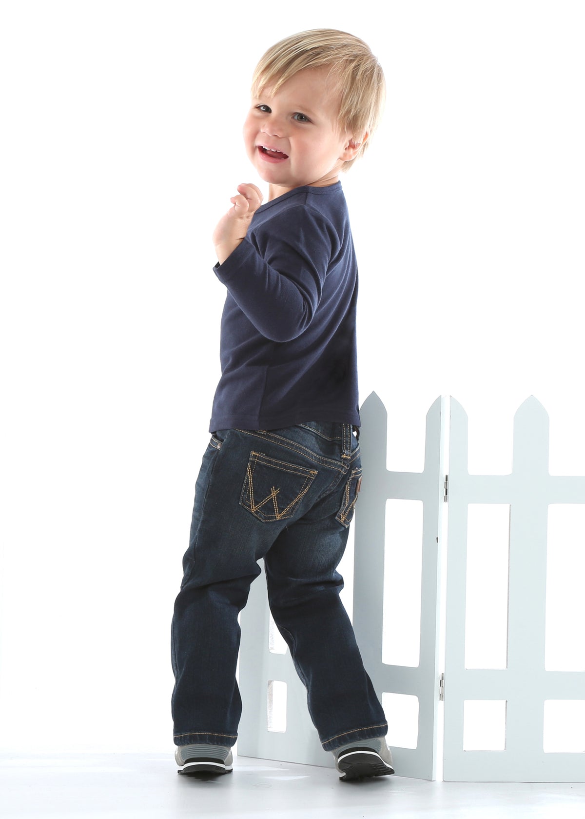 Infant-sized Wrangler western blue jeans with a classic 5-pocket design and 'W' embroidery on the back pockets, featuring spade hip pockets with embroidery and a patch.
