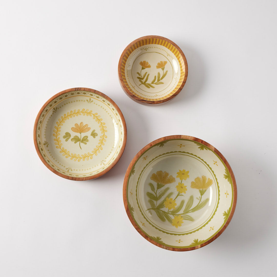 Three ceramic bowls with floral patterns on a white background