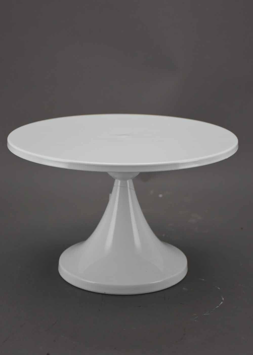 White cake stand on a dark background