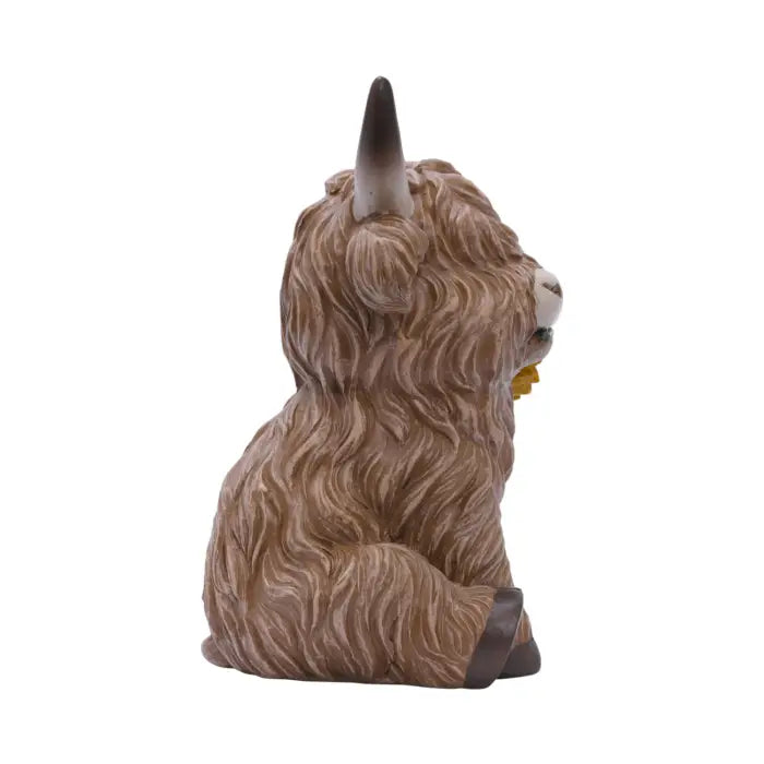 A small Highland cow figurine shown from the back and side, featuring shaggy brown and beige hair, dark brown hooves, and a small yellow bell, isolated on a white background.