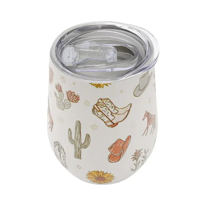 A white insulated stemless wine tumbler with a clear plastic lid, decorated with a western-themed pattern of boots, cowboy hats, a cactus, a horse, and flowers.
