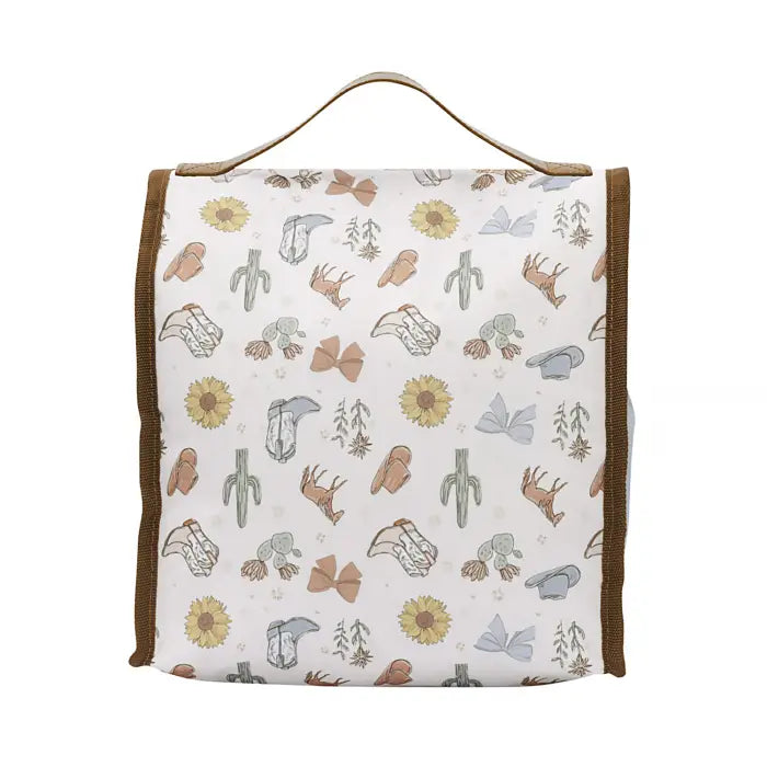 A rectangular fabric storage bag or organizer with a top handle, featuring a western-themed pattern of cacti, bows, boots, and sunflowers on a white background with brown trim.