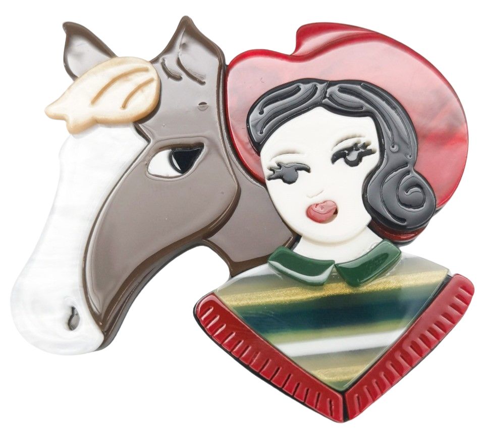 Iris Horsey Girl Brooch Red. Decorative item with a horse head and a woman's face on a white background
