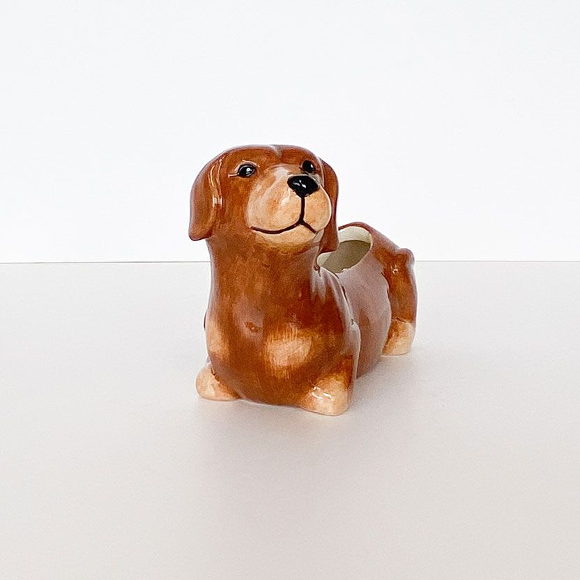 Dog-shaped ceramic planter on a white background