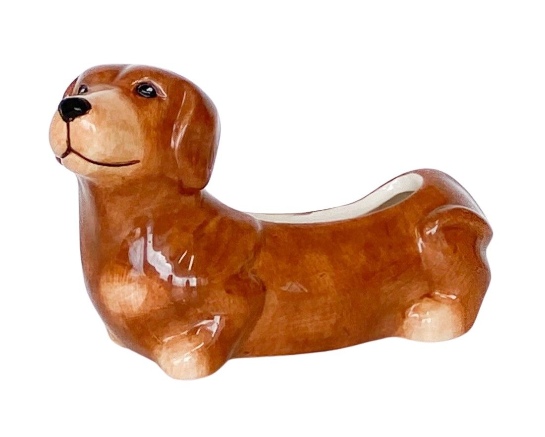 Brown ceramic dog-shaped object on a white background