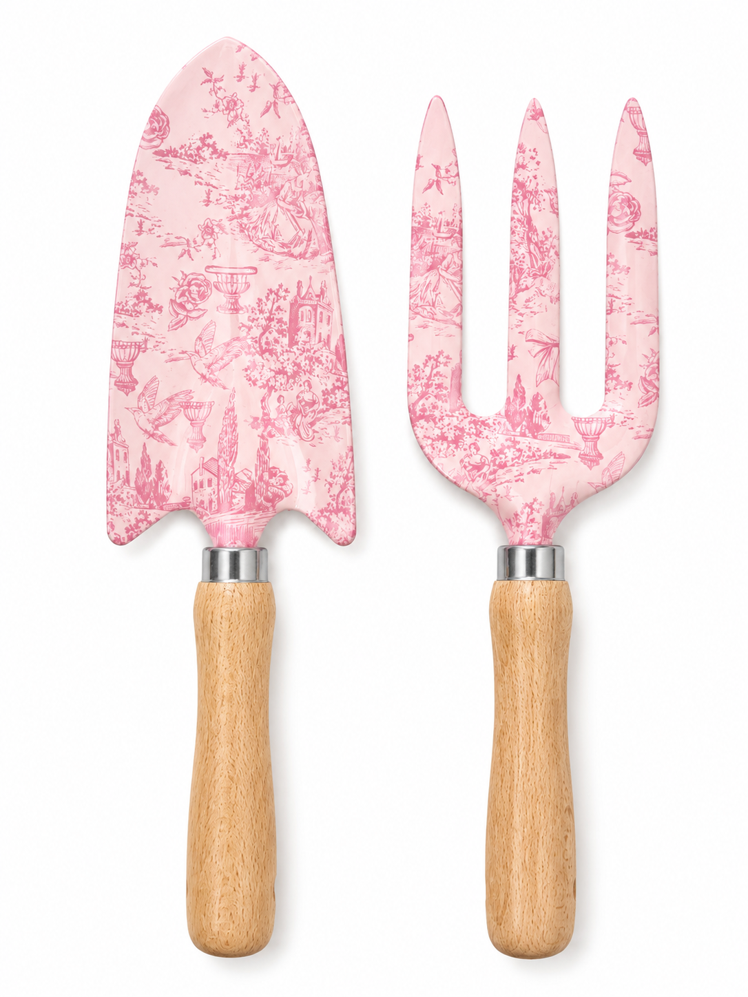 A garden tool set with a trowel and a three-prong fork, both featuring a pink and white toile pattern on the metal heads and light natural wood handles, shown against a plain white background.