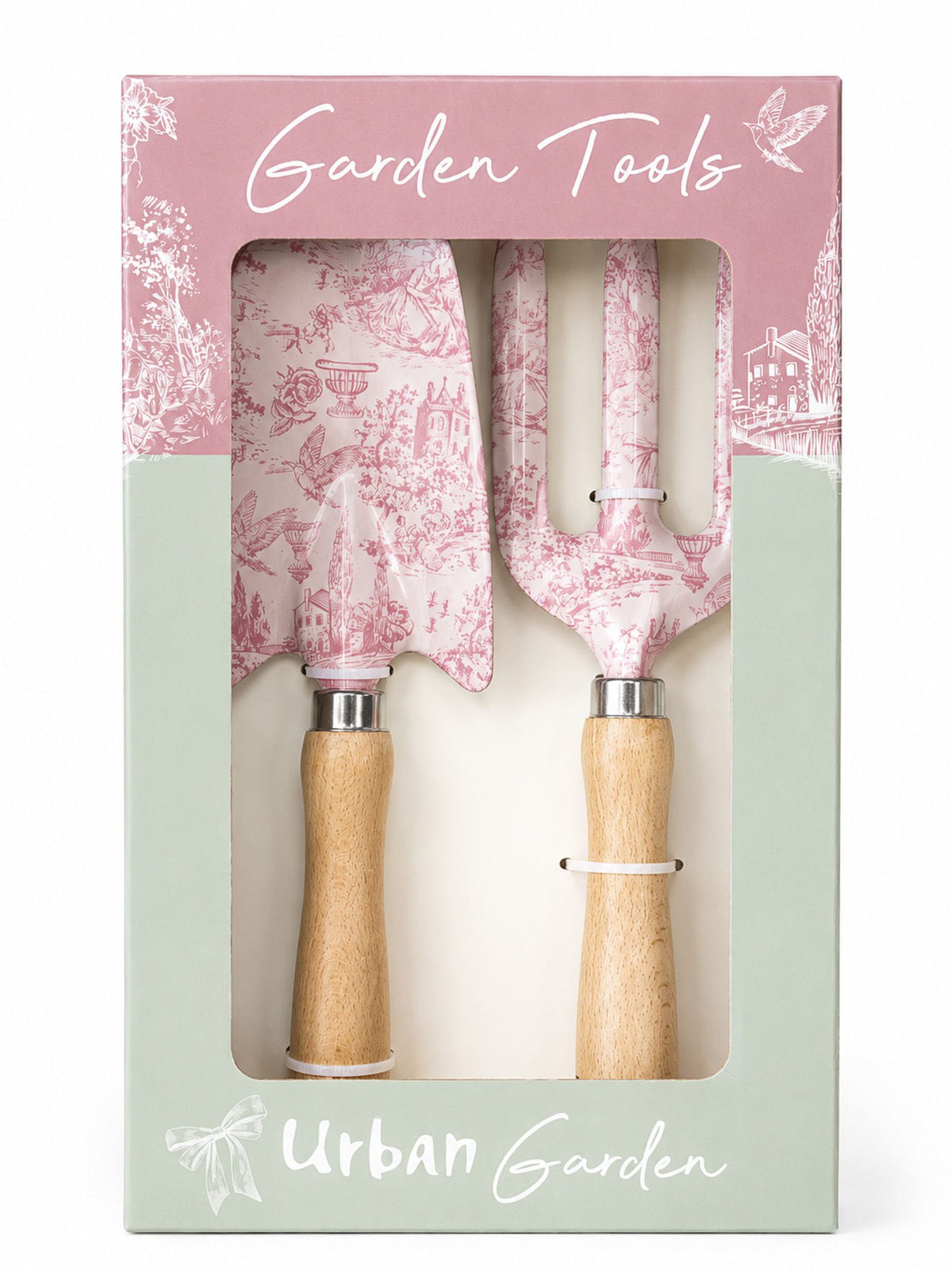 A boxed garden tool set with two hand tools visible through a clear window in the packaging. The tools have pink toile-style patterns and light wood handles, and the box is branded 'Garden Tools' and 'Urban Garden'.