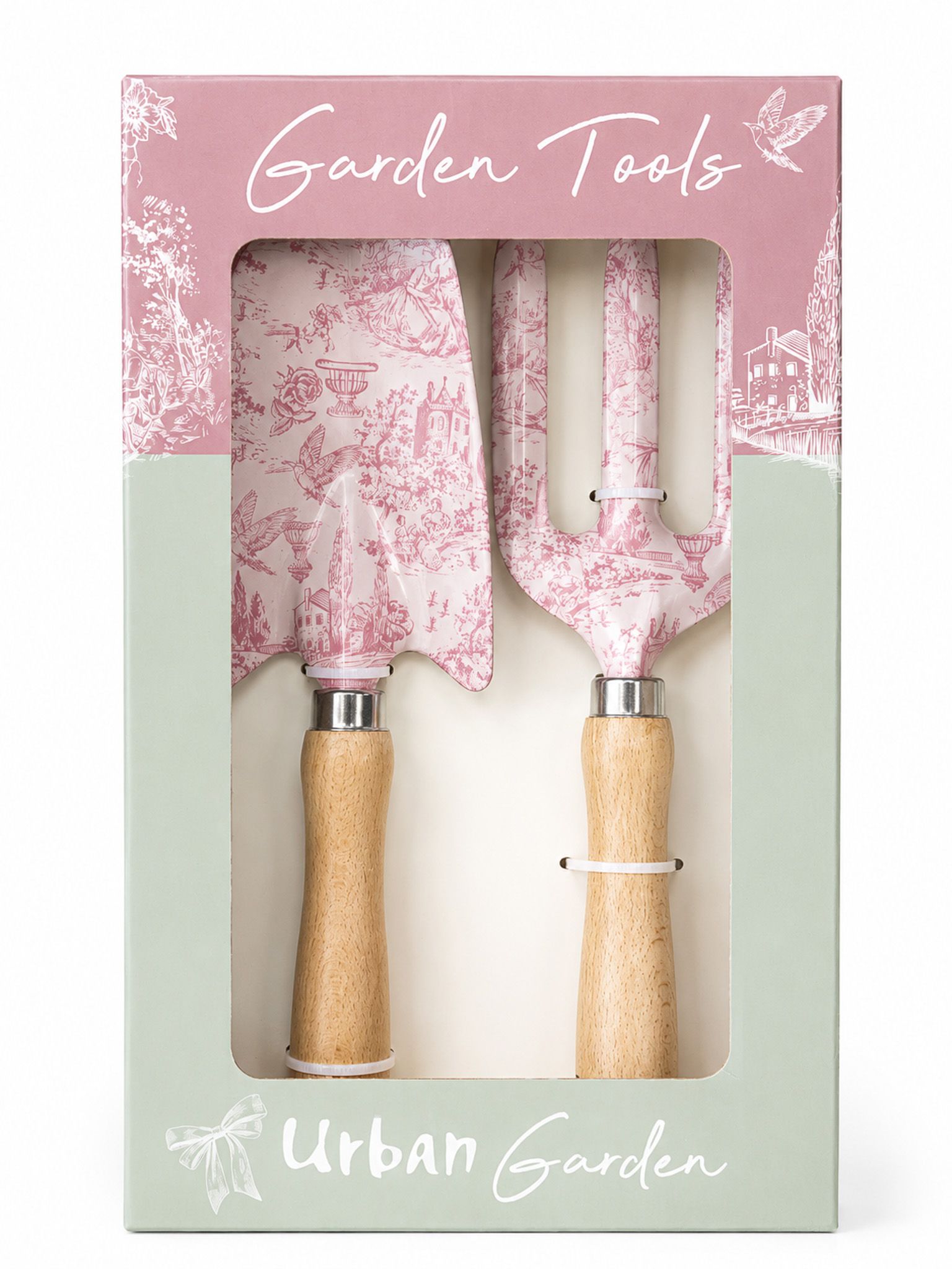 A boxed garden tool set with two hand tools visible through a clear window in the packaging. The tools have pink toile-style patterns and light wood handles, and the box is branded 'Garden Tools' and 'Urban Garden'.