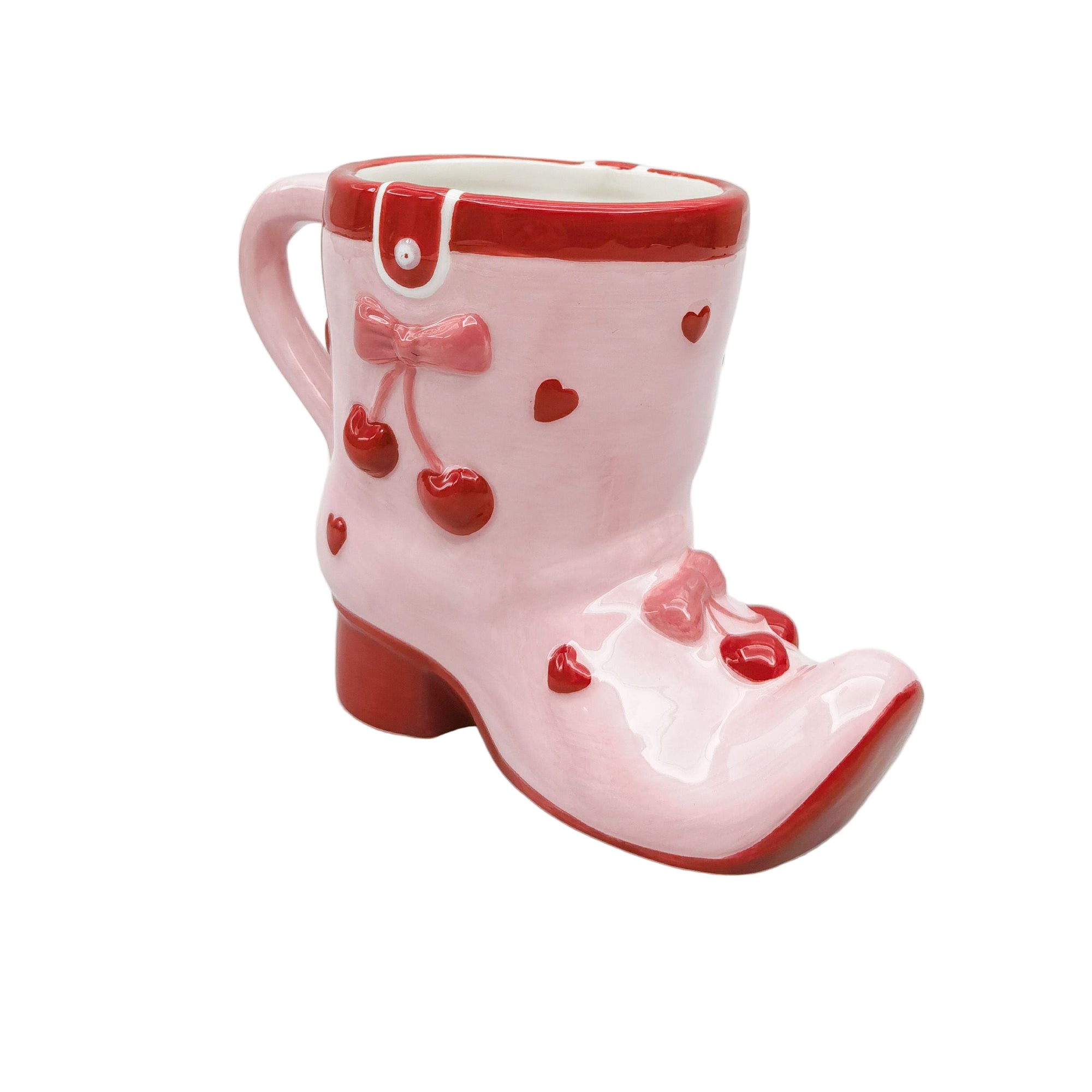Urban Products 12cm Cherry Boot Mug. Pink boot-shaped mug with red accents and decorative elements on a white background