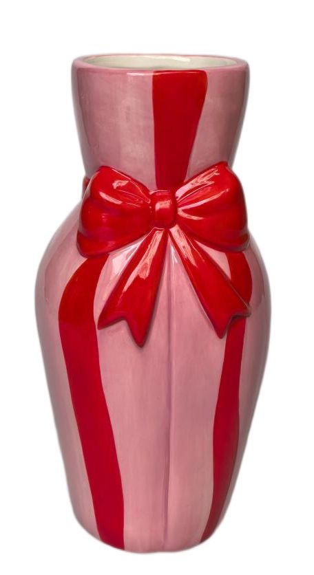 A glossy ceramic vase shaped like a gift box, featuring a pink base color with bold red vertical stripes and a large red ribbon bow on the front, set against a plain white background.