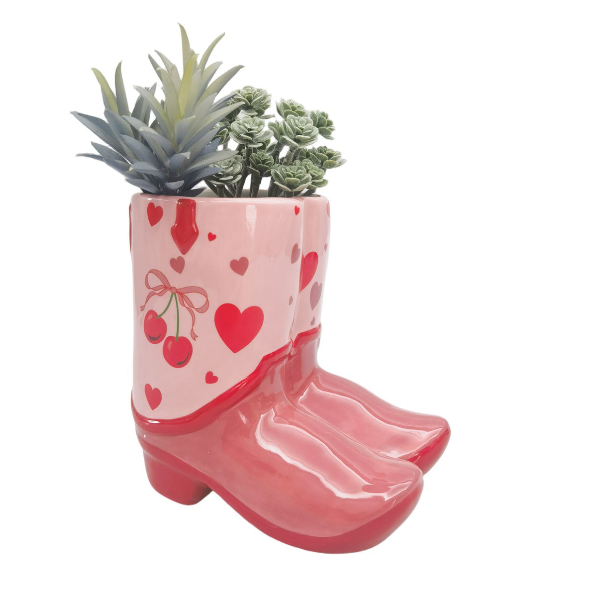 Urban Products 16cm Cowboy Boots Cherry Planter . Pink boot-shaped planter with succulents on a white background