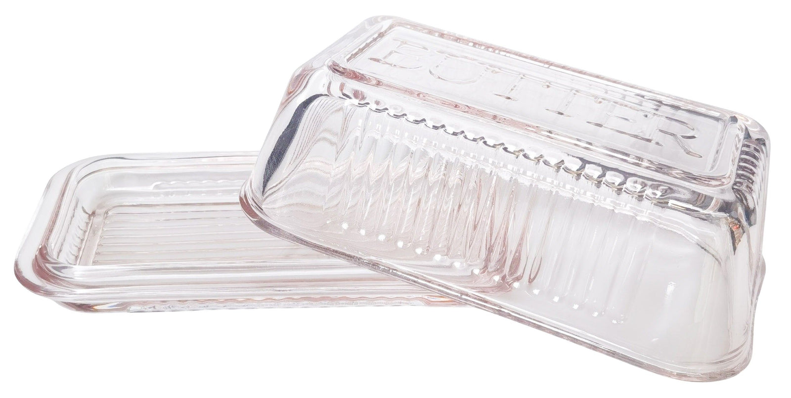 Clear glass butter dish with lid on a white background