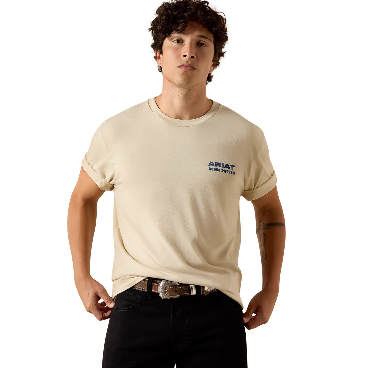 A man shown from the back wearing a cream-colored t-shirt with a large blue and brown graphic on the back that reads 'ARIAT 1993 RODEO PROVEN'.