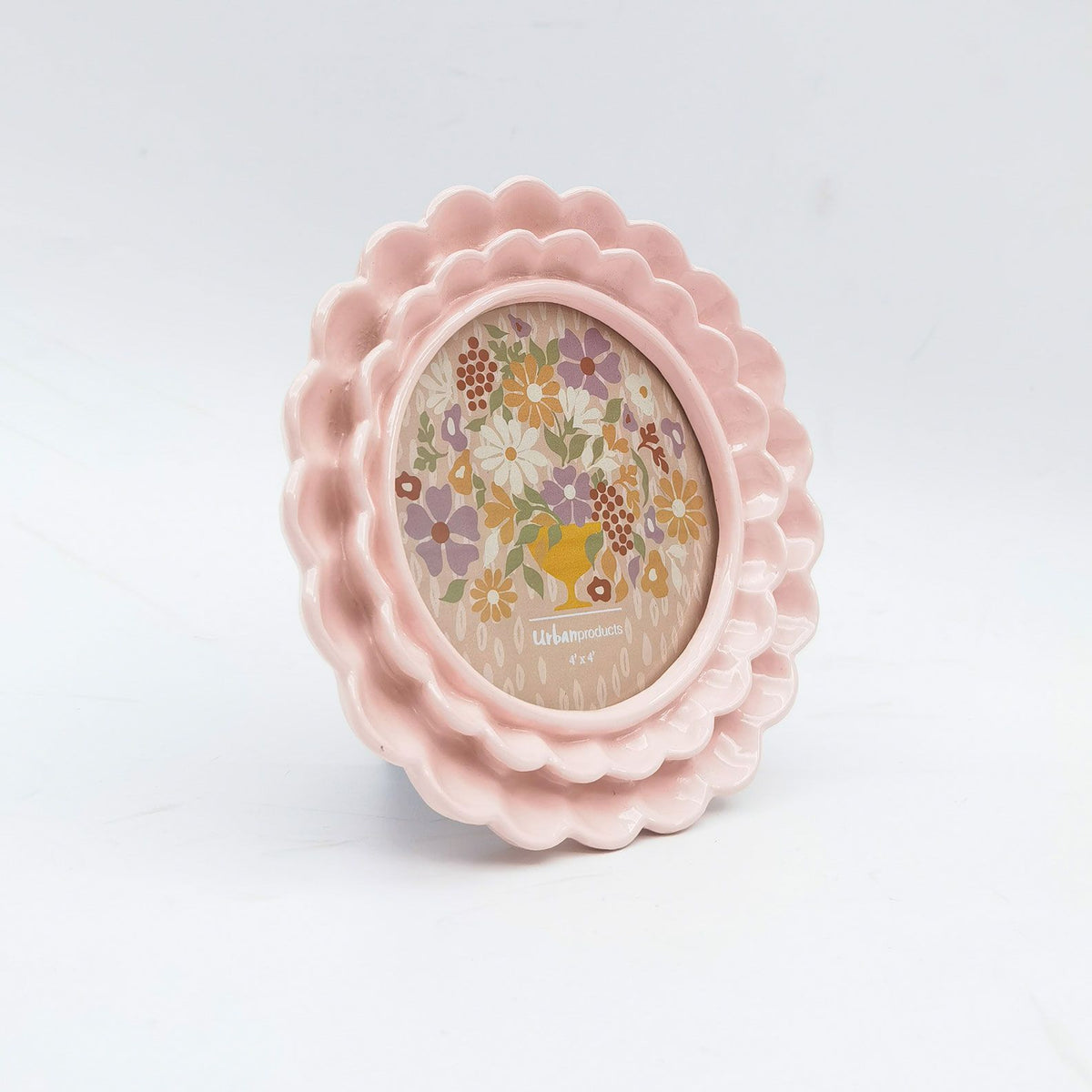 Urban Products Lotti Petal 4x4 Photo Frame. Pink scalloped-edge picture frame with floral design on a light gray background