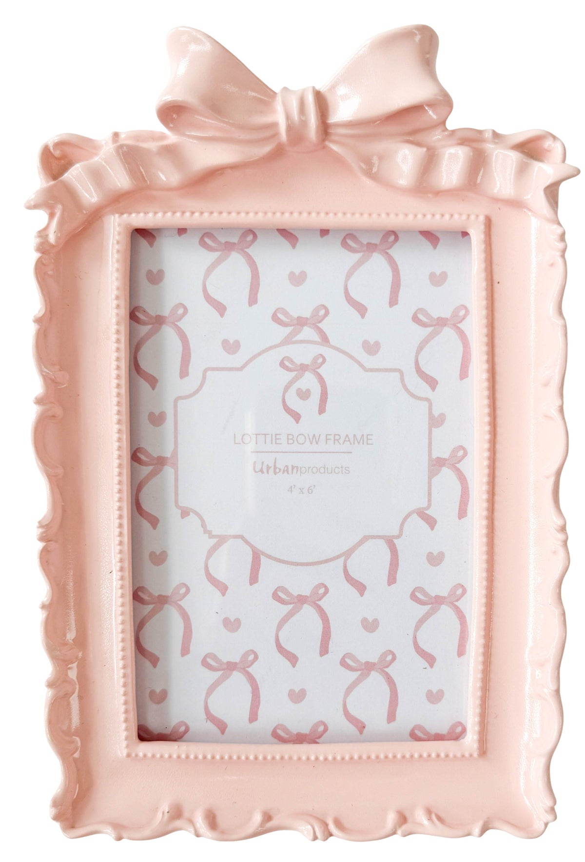Urban Products Lotti Bow Frame Pink. Pink decorative photo frame with a bow on top, featuring a pattern of bows and hearts on the glass.
