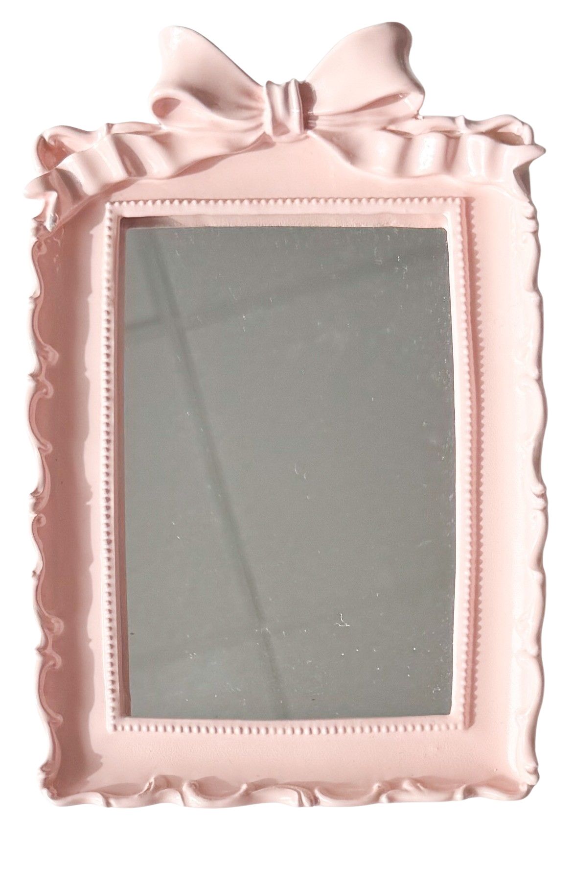 Urban Products Lotti Bow Mirror Pink. Pink decorative mirror with a bow on a white background