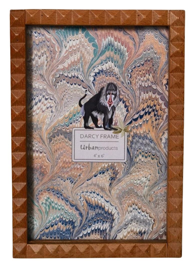 Decorative picture frame with intricate design and a label on a white background