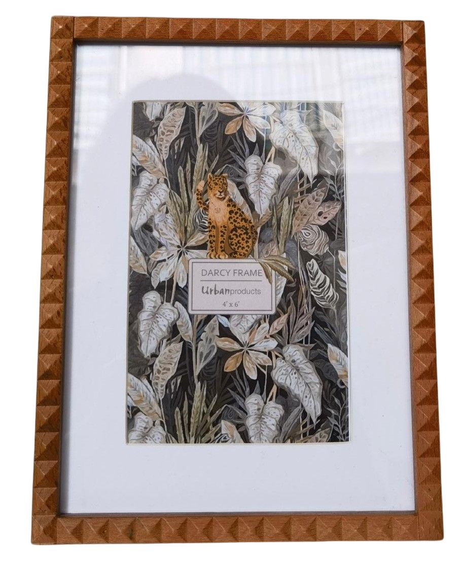 Framed artwork with a leopard and foliage design on a white background