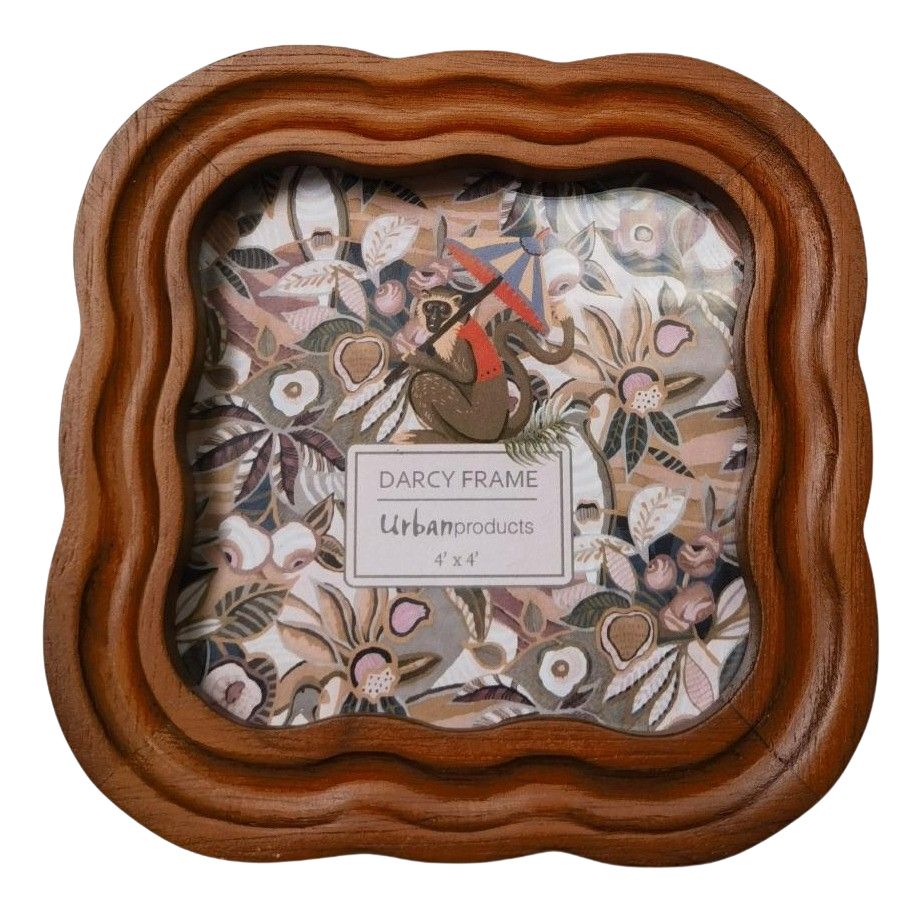 Wooden picture frame with decorative interior design and 'Darcy Frame Urban Products' label.