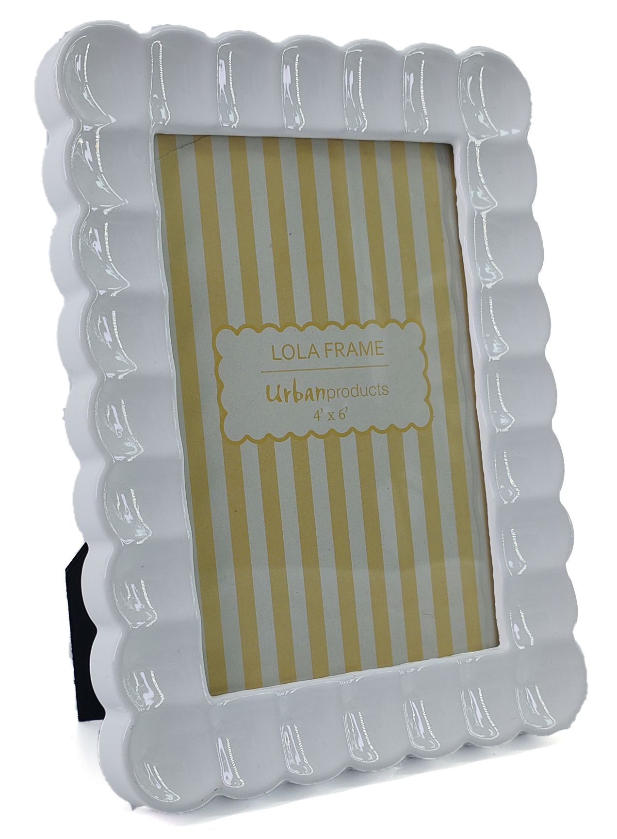 A white scalloped picture frame with a glossy finish, shown standing on a small black display base against a white background. The frame has a gold label in the center that reads 'LOLA FRAME Urban products 4 x 6'.