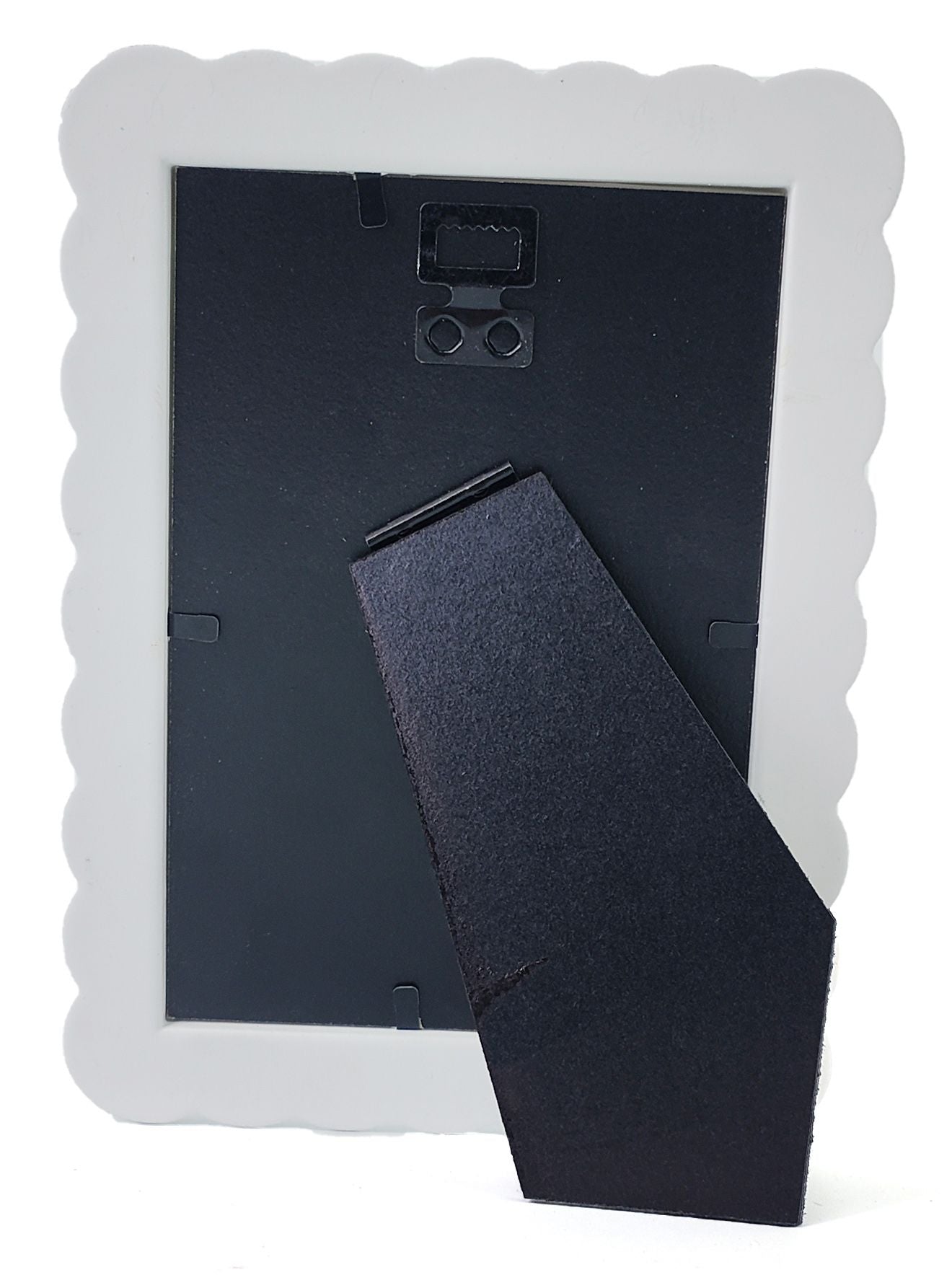 The back of a picture frame with a white scalloped border and a black hinged support stand, shown on a white background.