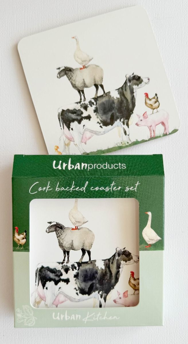 A cork-backed coaster set by Urban Products featuring a whimsical farm illustration with a sheep, cow, pig, goose, and chickens on a white background, shown with its green retail packaging.